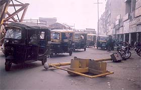 An uprooted traffic light pole obstructs the traffic on the busy Lakshmi Cinema Chowk on the Old GT Road