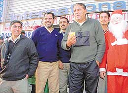 Former cricketer and actor Yograj Singh takes a sip of a drink at Bhatia International Supermarket
