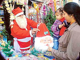 A man dressed as Santa sells Christmas knick-knacks in Ludhiana on Thursday.