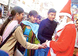 A man dressed as Santa mingles with people in Chaura Bazaar in Ludhiana