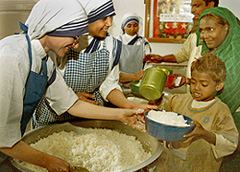 Catholic nuns with the Missionaries of Charity distribute free food to the poor on Christmas in Kolkata