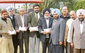 Members of the delegation of the Punjab and Haryana High Court Bar Association, on their return from Pakistan, display packets containing the sand of Ravi, Jhelum and Chenab rivers and Lahore City at Chandigarh on Saturday.