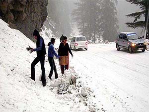 Tourists enjoy the fresh snowfall in Kufri, near Shimla