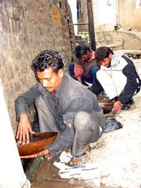 Bitto, Jasbir and Shinda hunt for gold from a drain flowing in the old city of Jammu