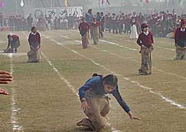 A competitor loses her balance during the sack race in the 8th annual sports meet of BVM School, Ludhiana, on Saturday.