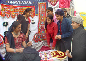 Girls from Gujarat display the handicraft of their state at an exhibition held on the concluding day of a national integration camp on Saturday.