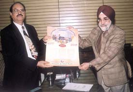 General Manager of Punjab & Sind Bank H. S. Duggal releasing the bank's 2004 wall calendar. Executive director of the bank Prakash Singh is also seen.
