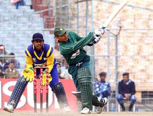 Pakistani batsman N. Latif hits the ball to the boundary while notching up an impressive 50 against Sri Lanka