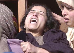A relative of Bilal Ahmad wails after he was killed by unidentified gunmen in Srinagar on Sunday.