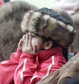 A young spectator braves the cold while witnessing the 64th anniversary CRPF day