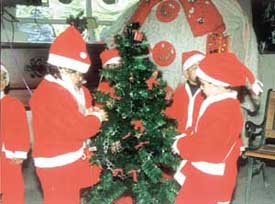 Students dressed up as Santa Claus at a Christmas celebration in Children�s Valley School, Preet Vihar.