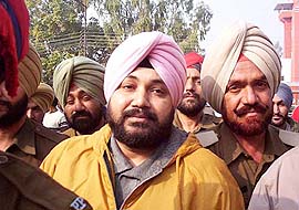 Daler Mehndi being led to a court in Patiala on Sunday.