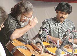 Pt Vishwa Mohan Bhat (left) and his son, Salil, perform at the 128th Harballabh Sangeet Sammelan in Jalandhar on Saturday night.