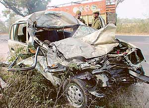 The mangled remains of a Santro car which collided head-on with a private bus