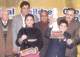 Parimarjan Negi and Devangi Patankar being felicitated by Bharat Chauhan, Sunit Sachar and Jhunjhunwala for their title wins in the National Under-11 Chess Championship at the Bapu Samaj Sewa Kendra in the Capital on Monday.
