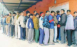 Residents queue up to deposit electricity bills outside a collection centre in Chandigarh