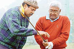 IS THIS GURU DAKSHINA? Former Indian cricket captain Kapil Dev gives tips to his coach Mr D.P. Azad on how to hold the golf club