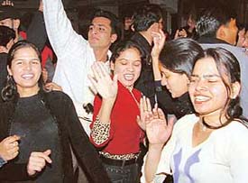 Youngsters dance to welcome the New Year during a party at a resort in Ludhiana on Monday.