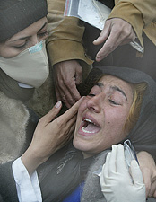 An unidentified Iranian woman mourns the death of her child following a mass burial at a cemetery in the ancient Silk Road city of Bam in southeast Iran 