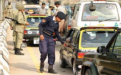 Vehicles are checked by security officials at a checkpoint in Islamabad 