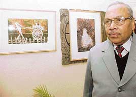 Dr Anand Agarwal with his paintings displayed at Indus Ind Art Gallery in Sector 8, Chandigarh, on Thursday.