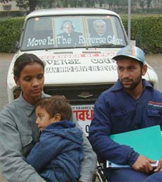 Harpreet Pappu along with his wife Krishna Devi and son Abu sits near their car in Amritsar 