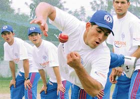Afghan under-17 cricket players warm up during a practice session in Chandigarh