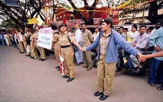 College students form a human chain to protest against acid attacks on women in Bangalore