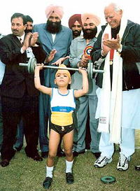 Dara Singh looks on as Pargat Singh (6) lifts 20 kg weight during the International Kabaddi Tournament in Ludhiana on Saturday.