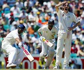 India's Sachin Tendulkar runs between wickets with V.V.S. Laxman as Australia's Jason Gillespie reacts during the second day of their fourth Test in Sydney