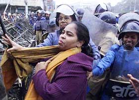 Bangladesh police arrest a woman activist during an Opposition-led strike in Dhaka on  Saturday.
