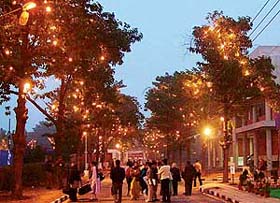 An illuminated pathway is dotted with delegates of the Indian Science Congress after the end of a session at Panjab University