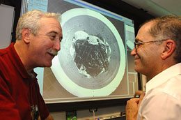 NASA Administrator Sean O'Keefe (left) and Dr Charles Elachi, Director, talk together while looking at the first images arriving from Mars after the landing of the Mars Exploration Rover Spirit on Saturday.