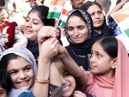 Muslim women, who have relatives in Pakistan, wave the Tri-colour at a function organised by local Muslim leaders
