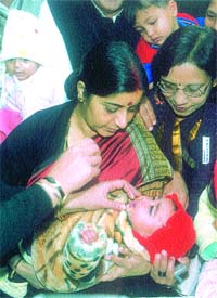 Union Health and Family Welfare Minister Sushma Swaraj administering pulse polio drops to a child at Lajpat Nagar in the Capital