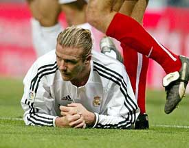 Real Madrid�s English player David Beckham lies on the pitch after a clash with a Real Murcia player