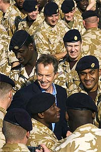 Tony Blair meets British troops as he arrives in the city of Basra, southern Iraq, during a surprise visit to the region