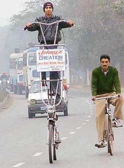 Chandigarh resident Rajiv Kumar on his 7.6-feet-high cycle