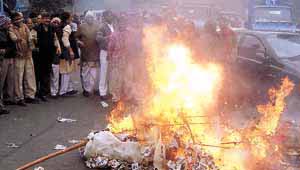 BJP activists burning an effigy of Delhi Chief Minister Sheila Dikshit against the continuing power problem at JJ.Colony in Wazirpur area in the Capital