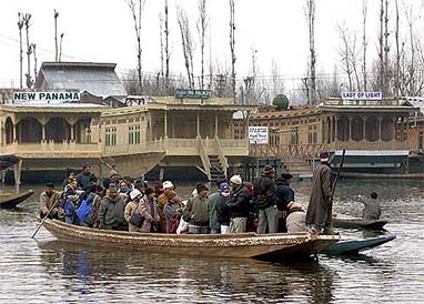 Tourists enjoy a boat ride in Dal Lake on a cold Tuesday morning in Srinagar