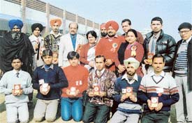 NSS volunteers, with their trophies, along with the SDM, Mr Kuldeep Singh and the Principal, SCD Government College, at Partap Singhwala village