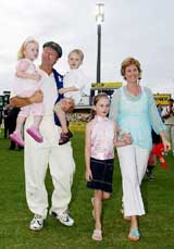 Australian captain Steve Waugh walks off the ground with his family 