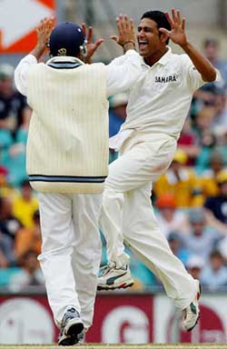 Anil Kumble celebrates with team-mate Rahul Dravid after taking the wicket of Australia's Damien Martyn on the final day of the fourth Test at the Sydney Cricket Ground on Tuesday. The match was drawn