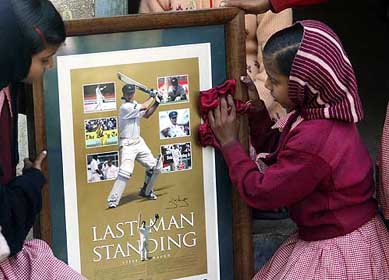 Girls of Udayan Home clean a photoframe of Australian captain Steve Waugh 