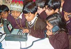 Students try out a videophone at the BSNL counter 