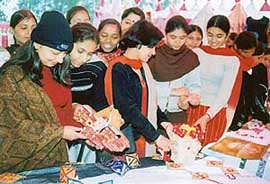 Visitors and students look at articles prepared by students of Government Institute of Textile 