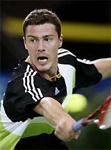 Marat Safin of Russia returns a shot to Jiri Novak of the Czech Republic during their match at the Hopman Cup team tennis tournament in Perth on Thursday