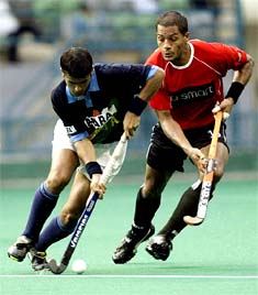 India's Sandeep Michael dribbles past Michael Green of Germany during their match at the Sultan Azlan Shah Cup Hockey tournament in Kuala Lumpur on Thursday