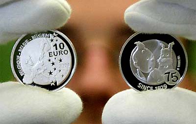 A Belgian central bank employee displays the newly minted 10-euro silver coin, commemorating the 75th anniversary of Tintin, in Brussels on Thursday