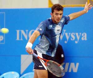 Terry Ascione of France makes a backhand return against Prakash Amritraj 